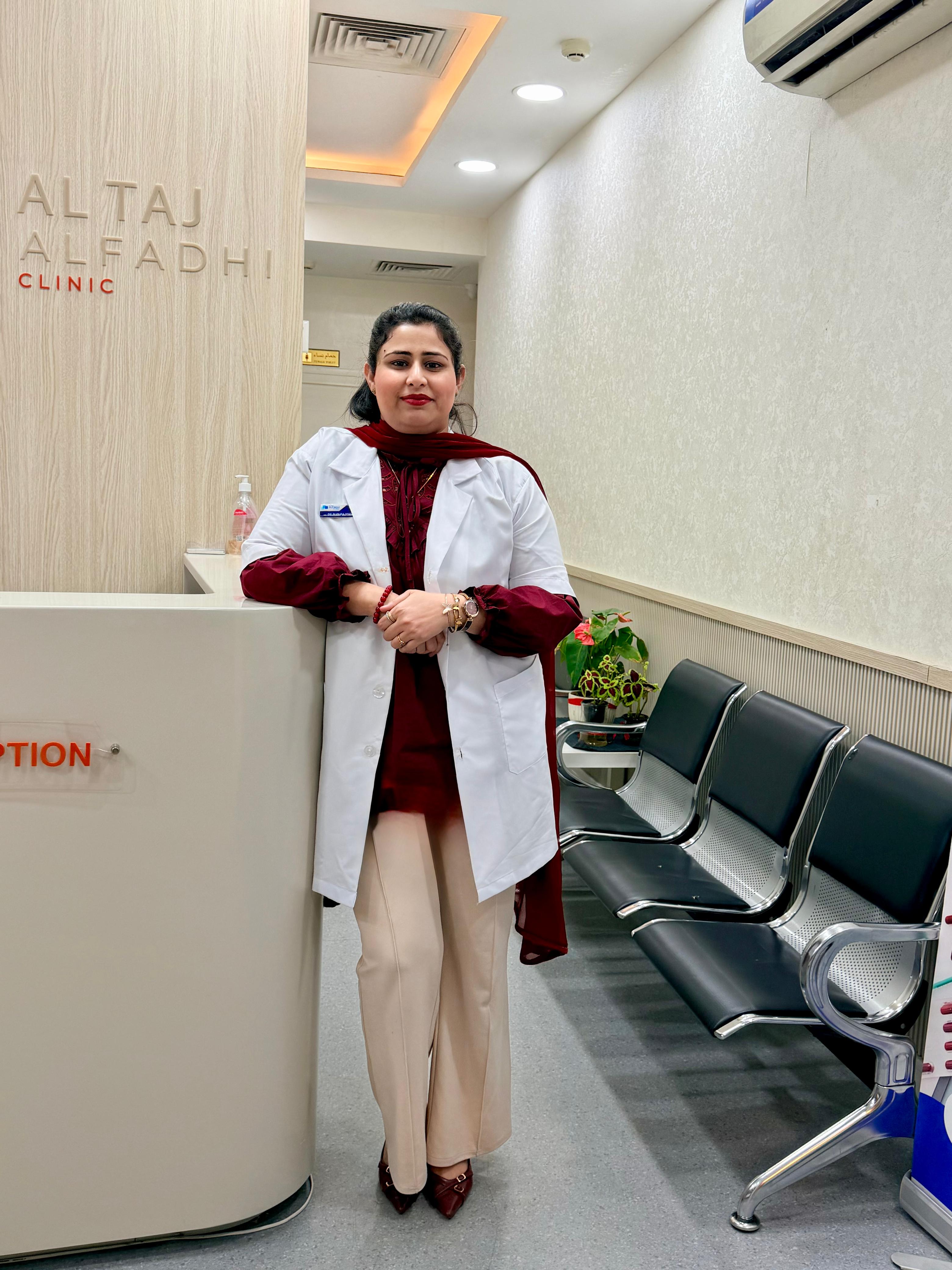 Dr. Bushra Sobia, owner of Al Taj Alfadhi Clinic, standing in the clinic reception